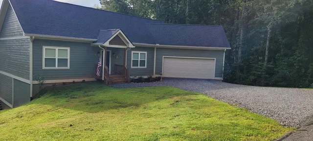 a view of house and yard with green space