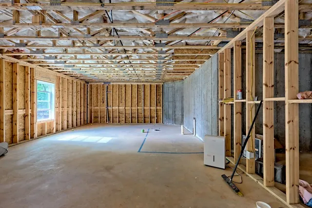 a view of a hallway with workspace and living room