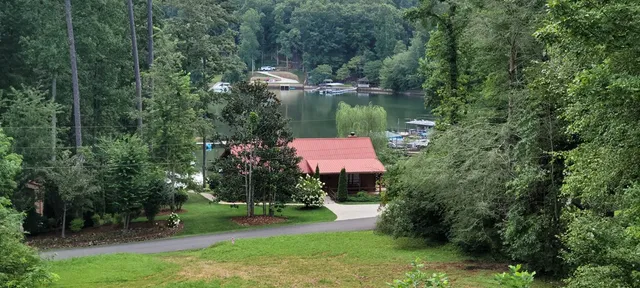 a living room with furniture a fireplace and a floor to ceiling window