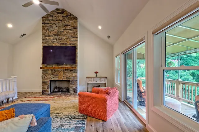 a bedroom with a bed and a flat tv screen on dresser