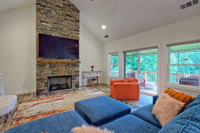 a bedroom with a bed and a dresser with wooden floor