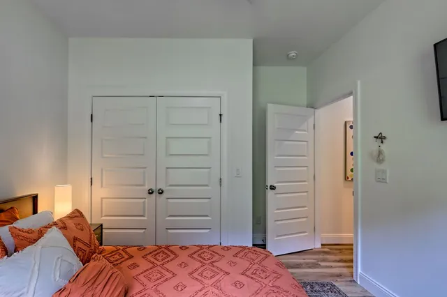 a kitchen with kitchen island granite countertop wooden floors and white cabinets