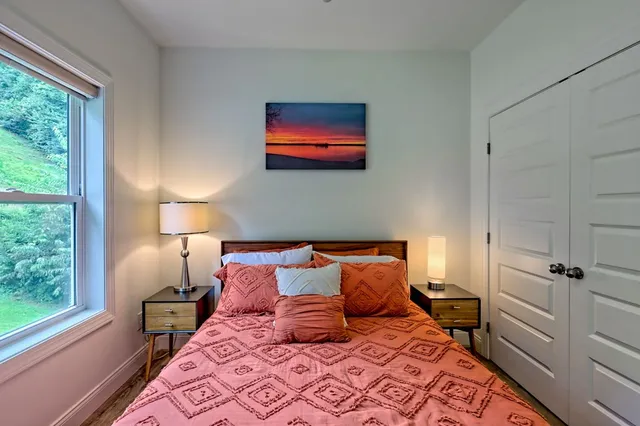 a kitchen with stainless steel appliances granite countertop a table chairs and a refrigerator