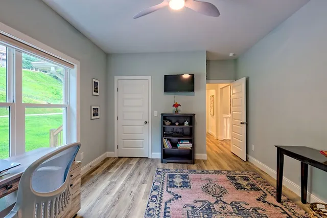 a open kitchen with stainless steel appliances granite countertop a stove and white cabinets with wooden floor
