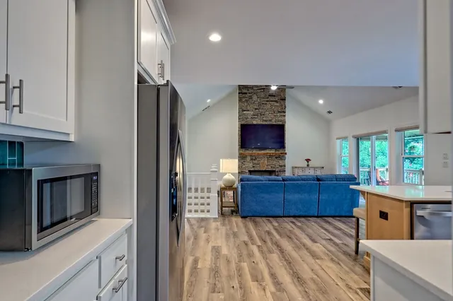 a view of a hallway with wooden floor and staircase