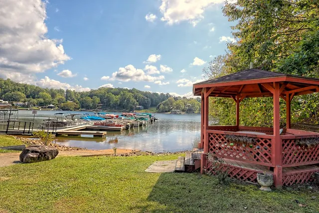 a view of a lake with couches and wooden floor