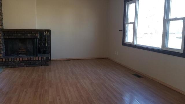 133 Heathgate Road Montgomery, IL 60538 - Photo 14 of 34 an empty room with wooden floor and windows