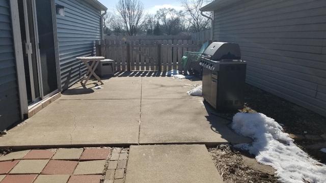 133 Heathgate Road Montgomery, IL 60538 - Photo 5 of 34 a bench sitting in front of a house