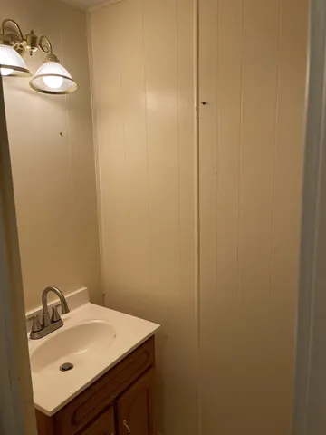 a white toilet sitting next to a small sink