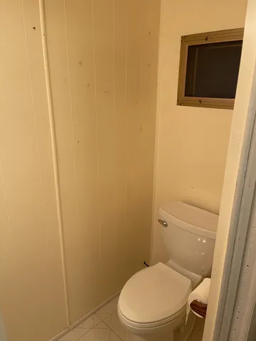 a bathroom with a toilet and a tub