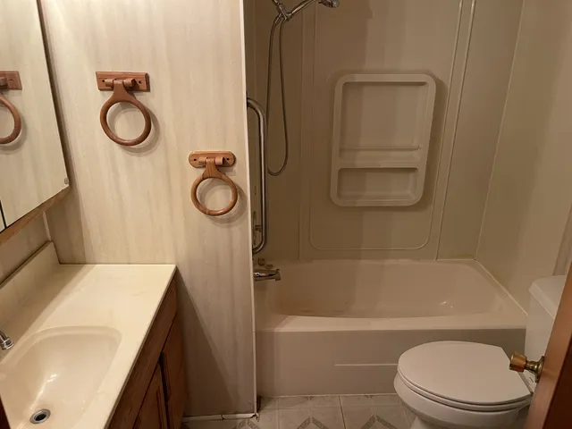 a view of empty room with cabinet and mirrors