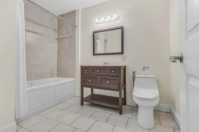 a bathroom with a toilet a sink and bathtub
