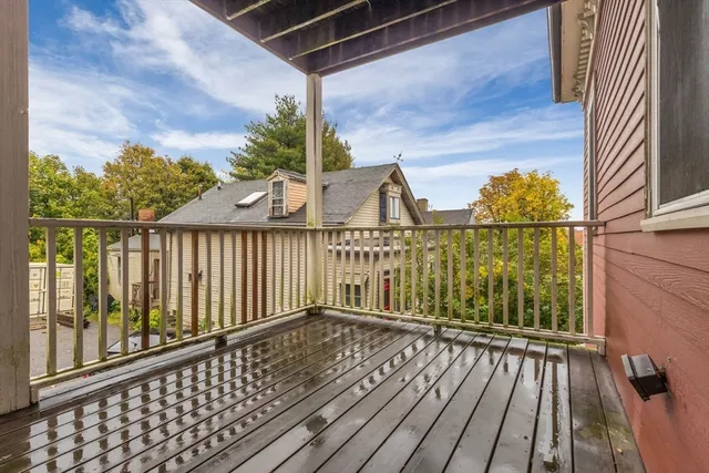 a view of a balcony with wooden floor and outdoor space