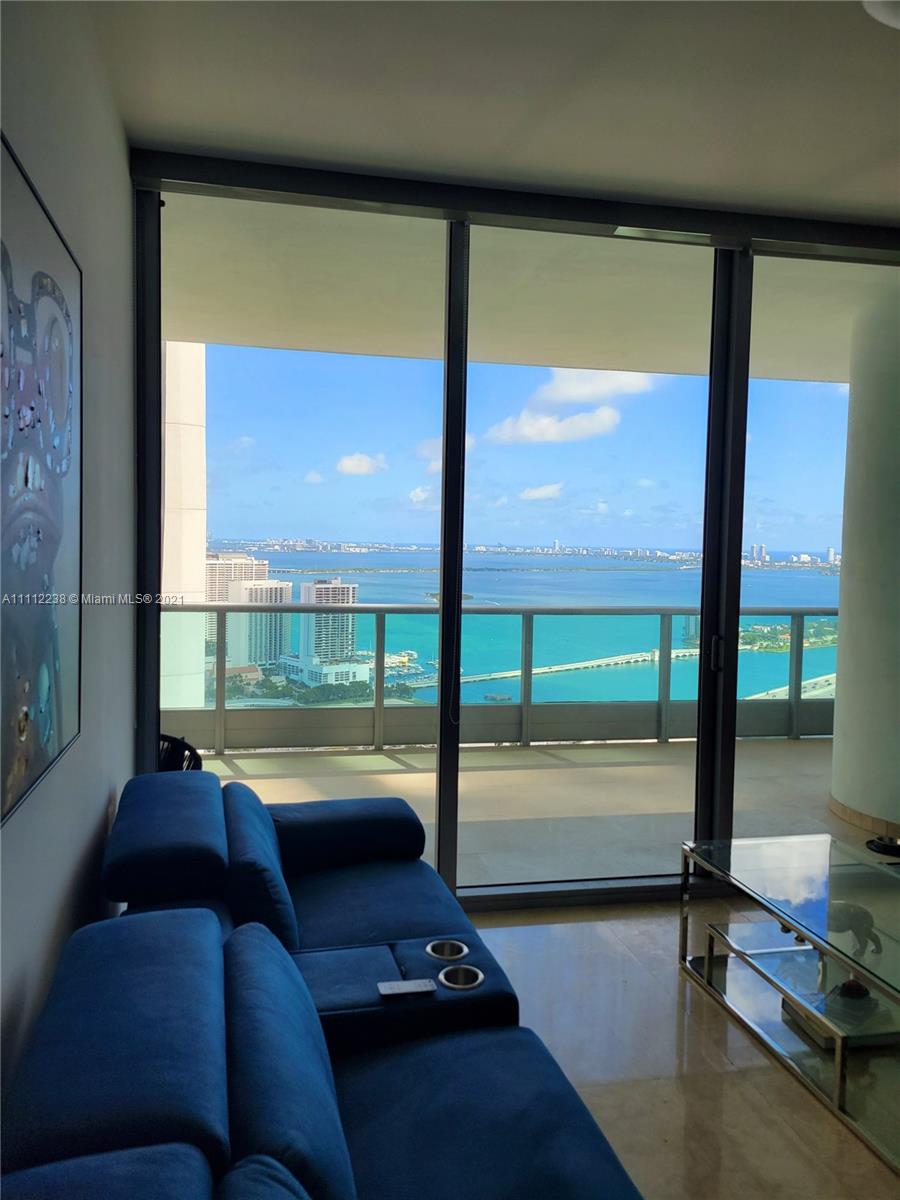 900 Biscayne Boulevard, Unit 4708 Miami, FL 33132 - Photo 20 of 21 a living room with hardwood floor and a floor to ceiling window