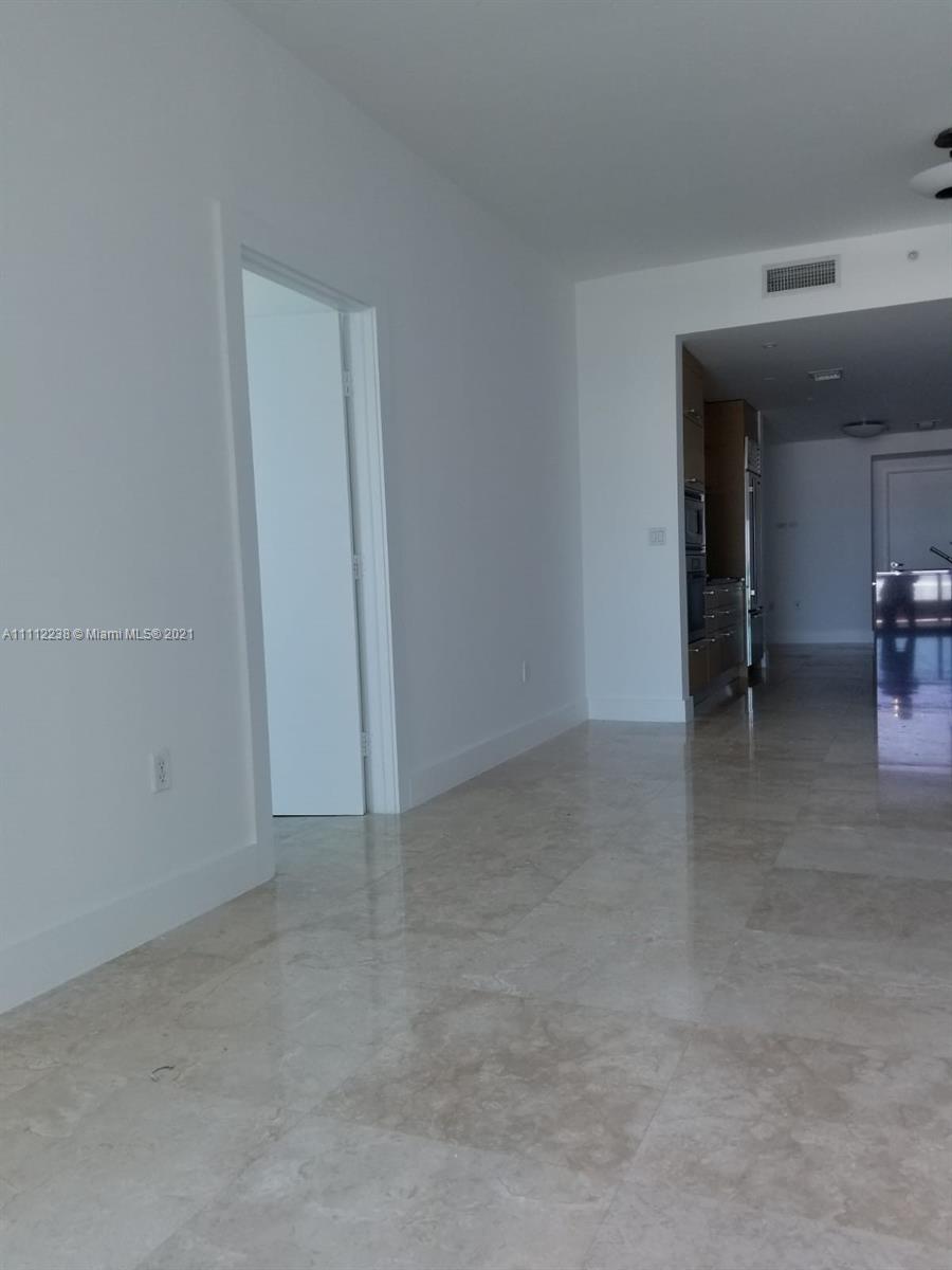 900 Biscayne Boulevard, Unit 4708 Miami, FL 33132 - Photo 4 of 21 an empty room with furniture and a window
