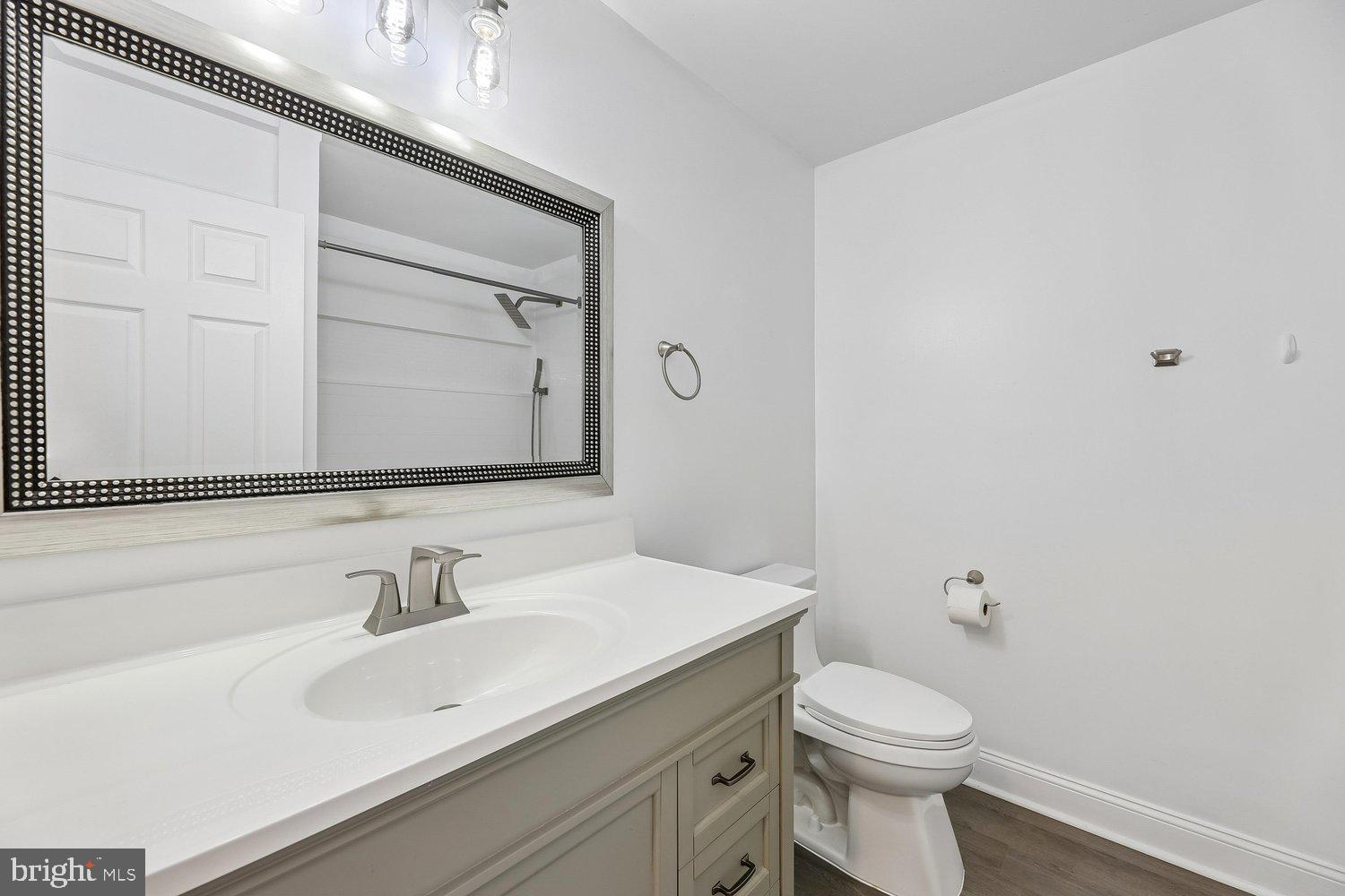 15764 Beau Ridge Drive Woodbridge, VA 22193 - Photo 37 of 58 a bathroom with a sink vanity mirror and toilet