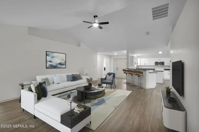 a living room with furniture and a flat screen tv