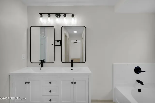 a bathroom with a double vanity sink