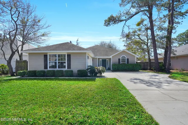a front view of a house with yard and green space
