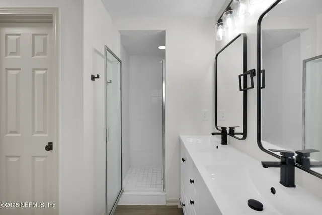 a bathroom with a double vanity sink