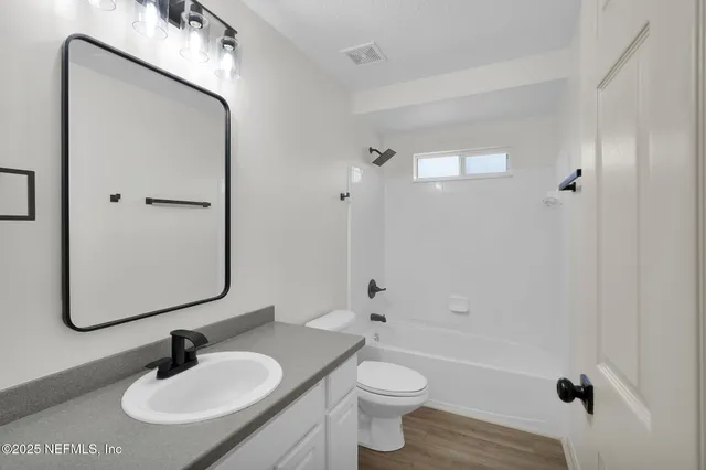 a bathroom with a sink toilet a shower and a mirror