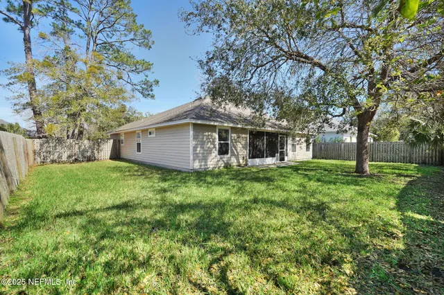 a view of a house with yard and tree s