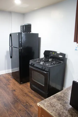 a kitchen with stainless steel appliances granite countertop a sink a stove and cabinets