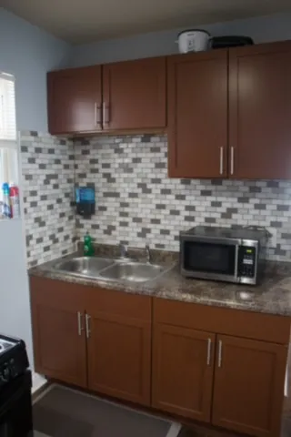 a bed sitting in a bedroom next to a wall