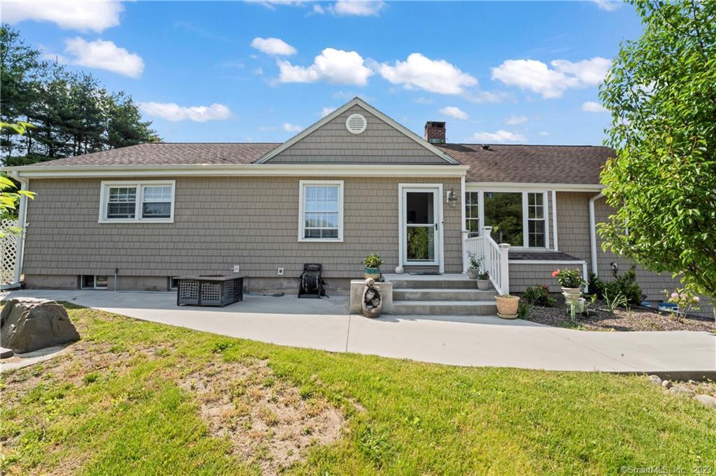 a front view of house with yard outdoor seating and barbeque oven