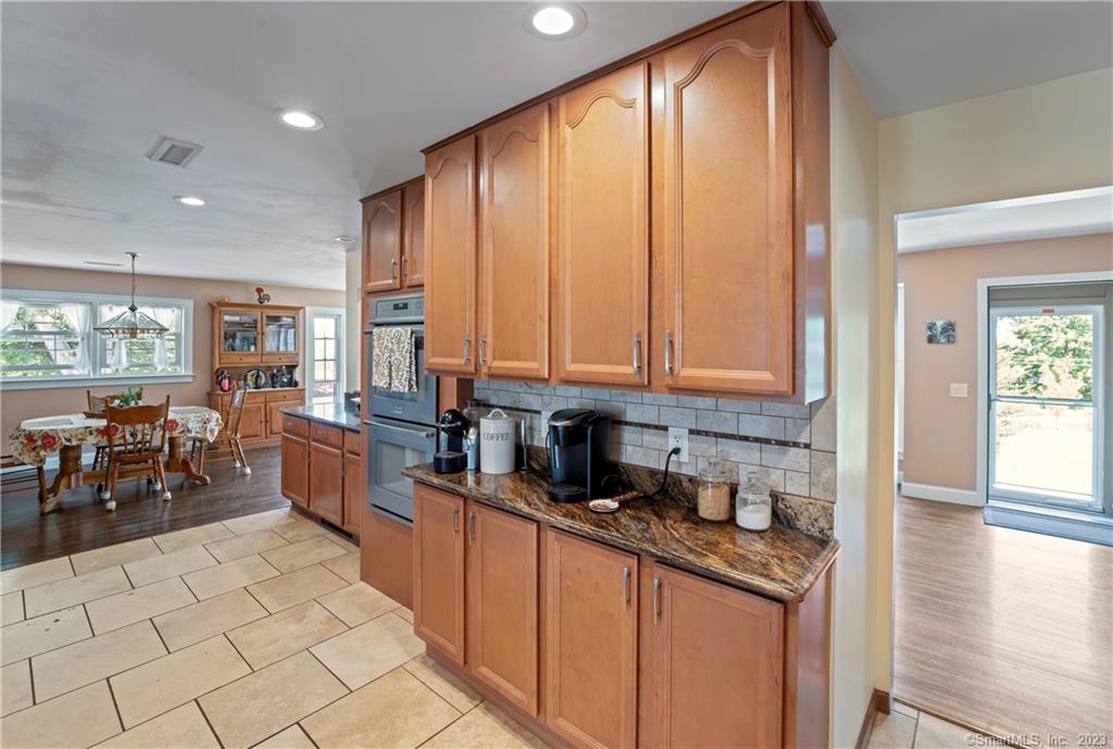 23 Sunset Hill Road Brookfield, CT 06804 - Photo 11 of 40 a kitchen with stainless steel appliances granite countertop a stove a sink and a microwave