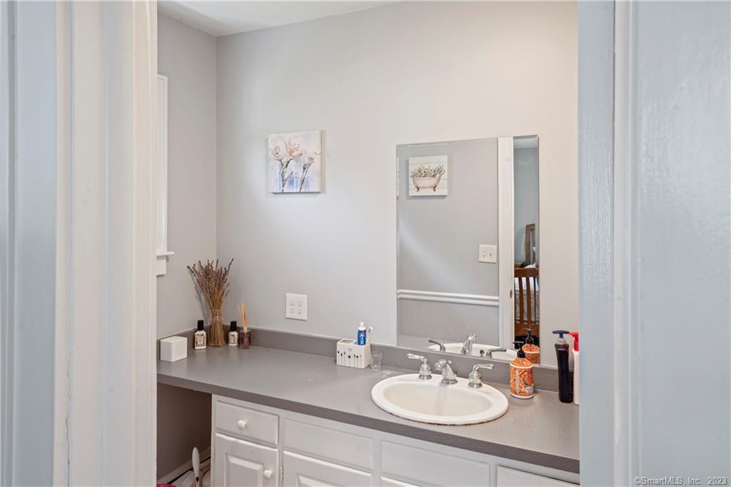 23 Sunset Hill Road Brookfield, CT 06804 - Photo 23 of 40 a bathroom with a sink vanity and a mirror