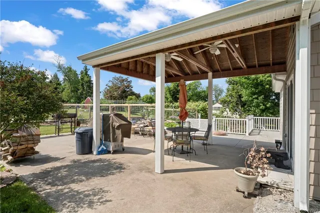 a view of a porch with chairs and floor to ceiling window
