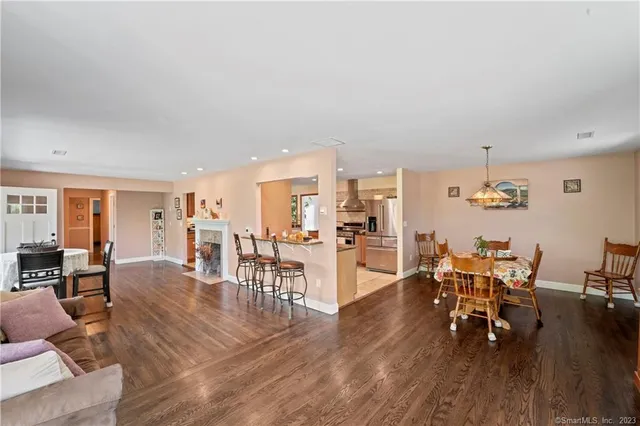 a view of a dining room with furniture and wooden floor
