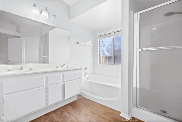 a bathroom with a tub sink and mirror