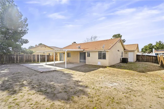 a view of a house with wooden fence