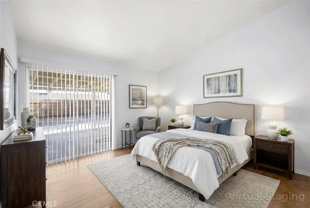 a bedroom with a bed and a night stand