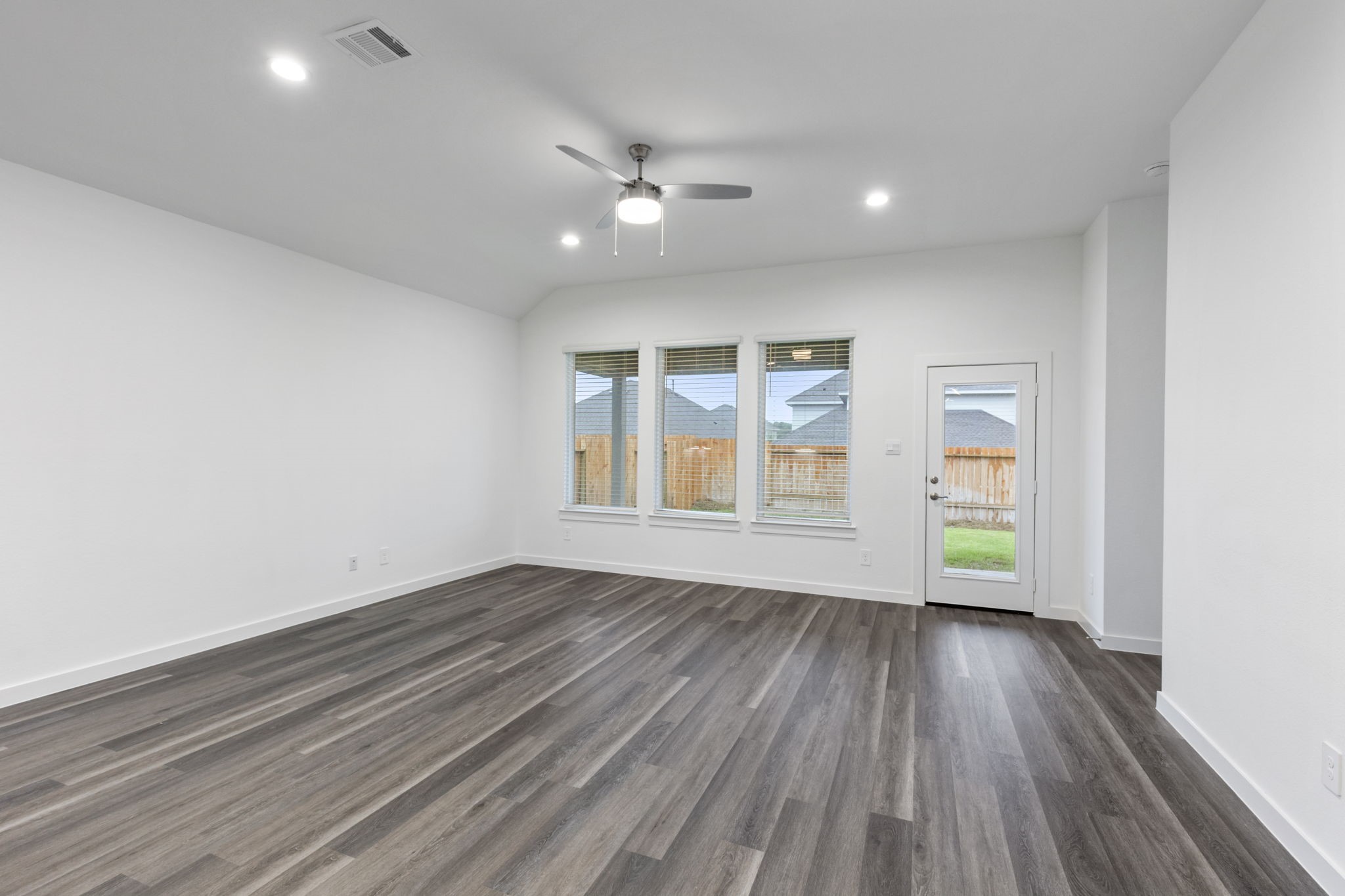 1589 Oakdale Crest Road Montgomery, TX 77316 - Photo 15 of 33 Recessed lighting, LVP flooring, ceiling fan, and blinds on the windows and backdoor.