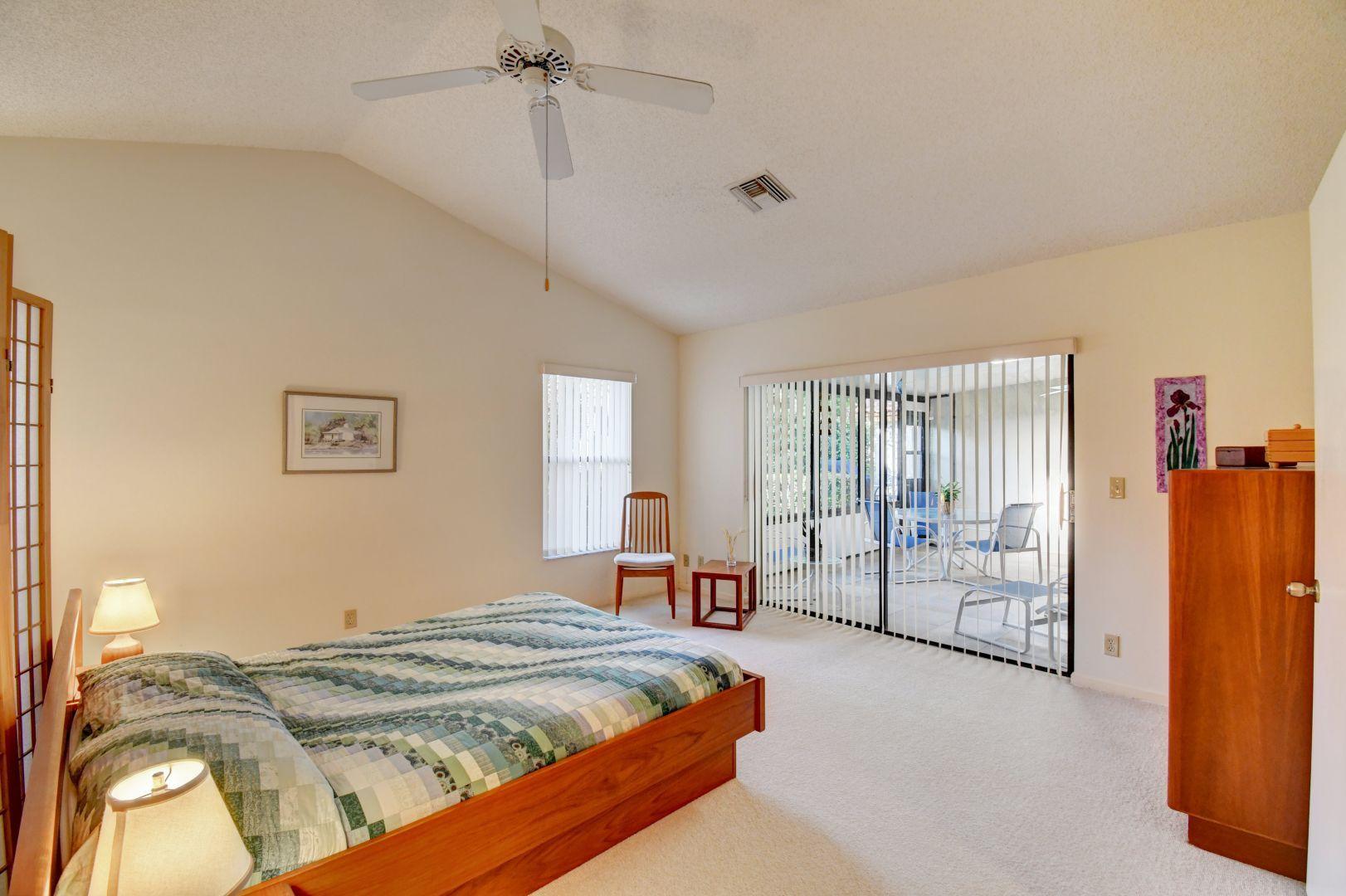 23383 Water Circle Boca Raton, FL 33486 - Photo 28 of 35 a bedroom with a bed and a refrigerator