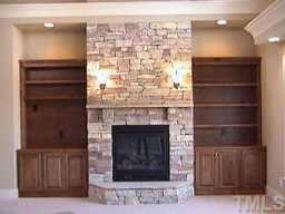 1132 Wakefield Farm Road Zebulon, NC 27597 - Photo 6 of 7 Stone fireplace with gas logs and custom stained bookcases flanking each side in two story Great Room. Other