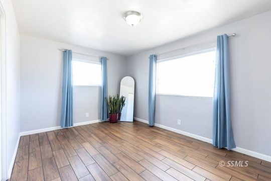 240 West Graaf Avenue Ridgecrest, CA 93555 - Photo 16 of 28 a view of an empty room with wooden floor and a window