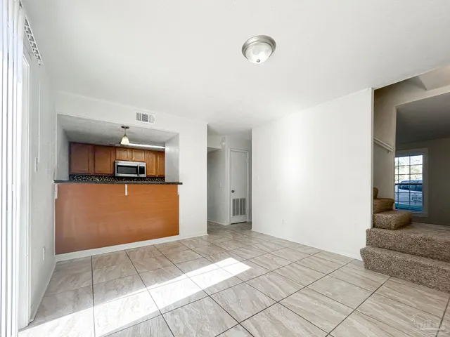 a view of a kitchen with a sink and a refrigerator