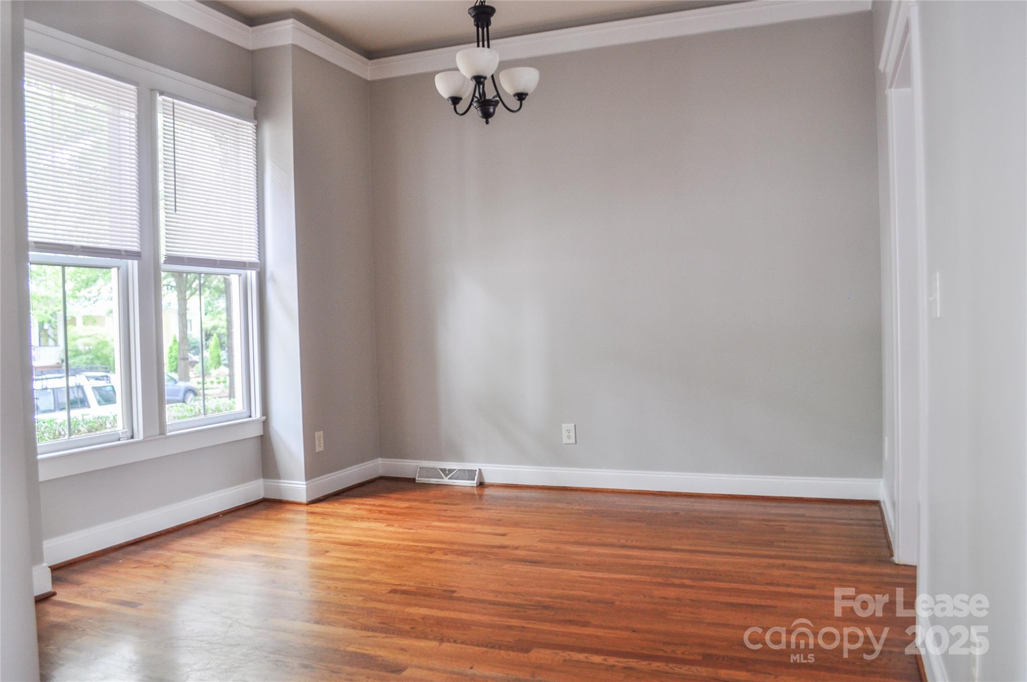 3010 Colonel Springs Way Fort Mill, SC 29708 - Photo 5 of 17 an empty room with wooden floor and windows