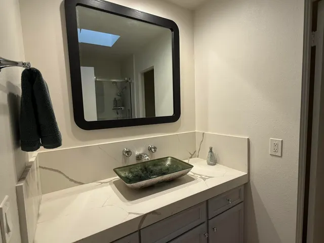 a bathroom with a sink and a mirror