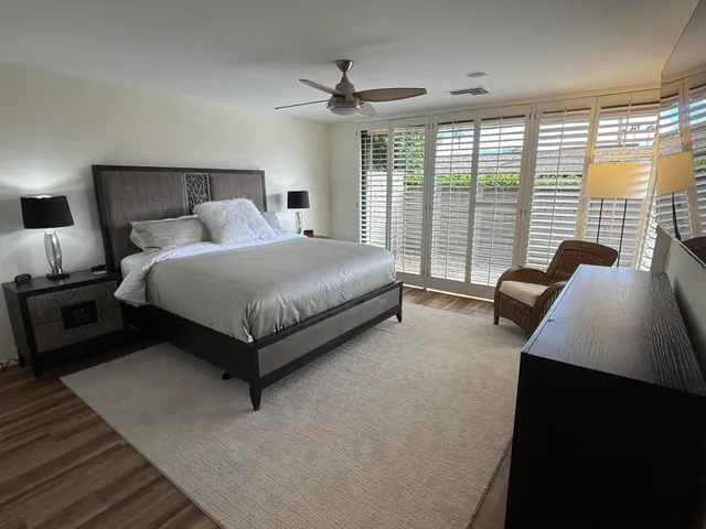 a bedroom with a bed and a large window