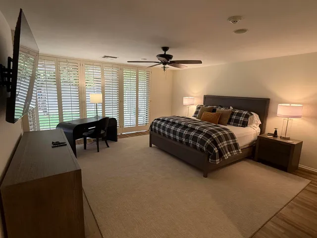 a large kitchen with kitchen island a counter top space a sink stainless steel appliances and cabinets