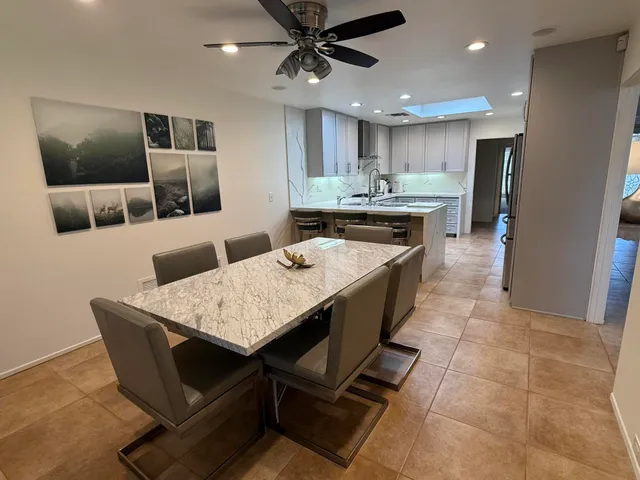 a spacious bathroom with a granite countertop sink toilet and shower