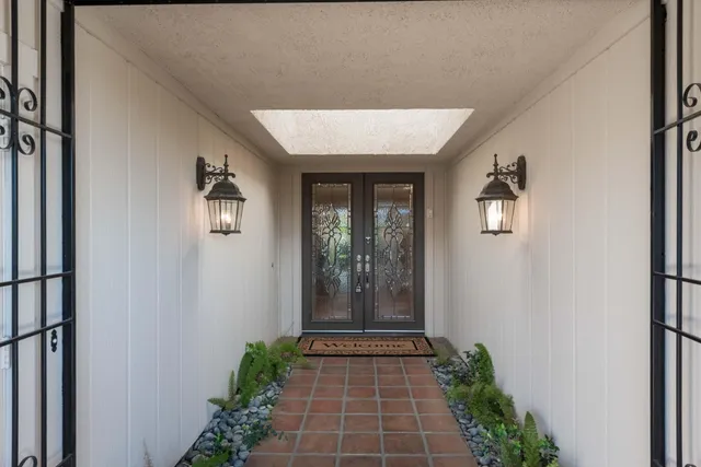 a view of a porch with furniture and floor to ceiling window