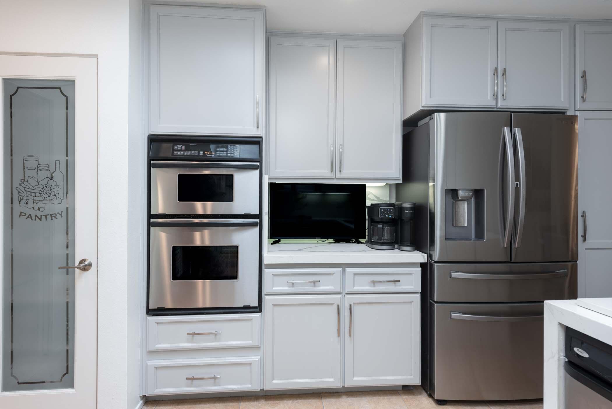 2 Lehigh Court Rancho Mirage, CA 92270 - Photo 23 of 43 a kitchen with white cabinets and stainless steel appliances