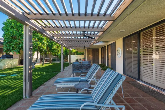 a view of hallway with wooden floor and furniture