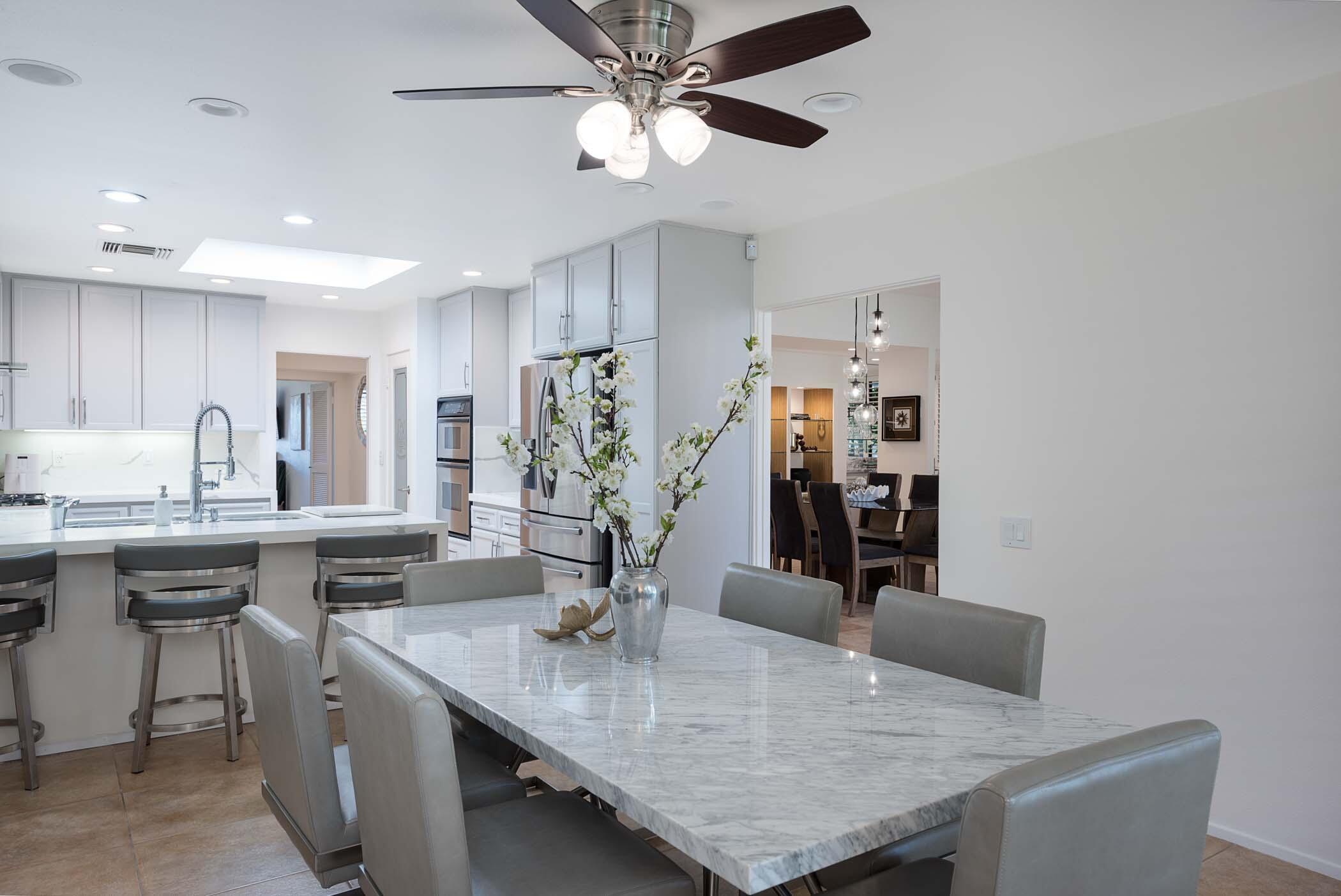 2 Lehigh Court Rancho Mirage, CA 92270 - Photo 2 of 43 a kitchen with stainless steel appliances granite countertop a sink dishwasher and a refrigerator with wooden floor